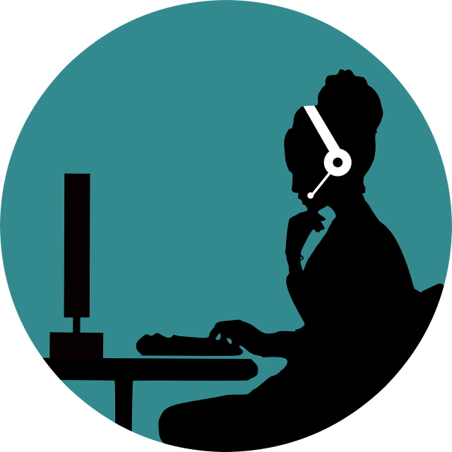 Person talking on a headset in front of a computer